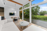 Experience modern living in this stunning property, featuring expansive windows that flood the space with natural light and offer breathtaking views.