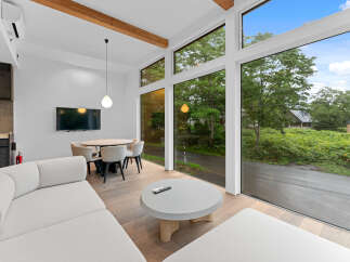 Experience modern living in this stunning property, featuring expansive windows that flood the space with natural light and offer breathtaking views.