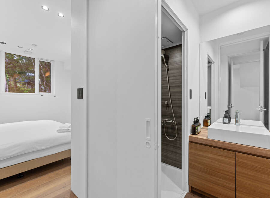 This modern property boasts a sleek bathroom design with a spacious shower and a stylish vanity.