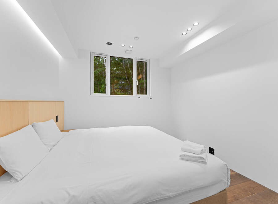 This modern bedroom offers a serene retreat with its minimalist design and bright, airy ambiance.