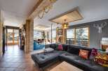 This stunning property boasts a spacious living area with a modern, L-shaped sofa, perfect for relaxing.