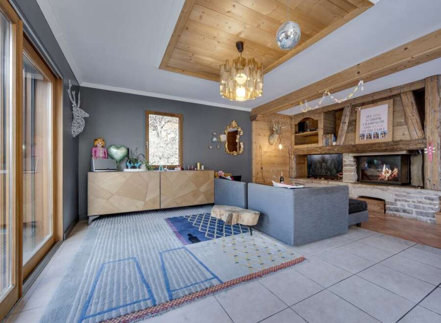 This stunning property boasts a cozy living room with a rustic fireplace, perfect for relaxing evenings.