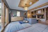 This stunning property boasts a cozy living room with a rustic fireplace, perfect for relaxing evenings.