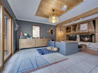 This stunning property boasts a cozy living room with a rustic fireplace, perfect for relaxing evenings.