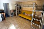 This cozy studio apartment features a unique loft bed, maximizing space and offering a modern living experience.