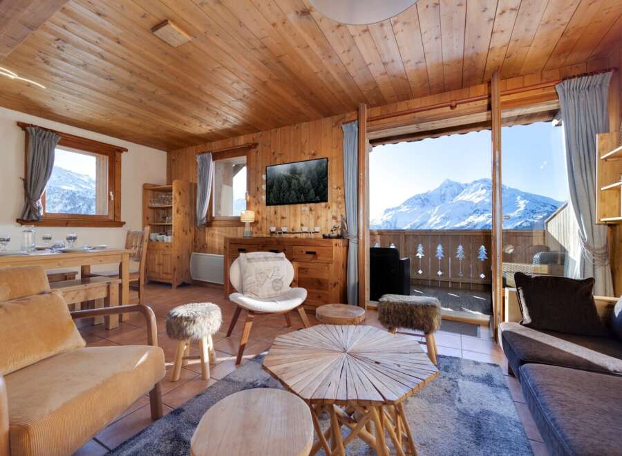 Experience the charm of this cozy chalet, boasting stunning mountain views from its balcony.