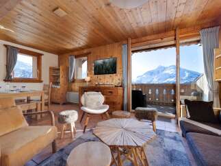 Experience the charm of this cozy chalet, boasting stunning mountain views from its balcony.