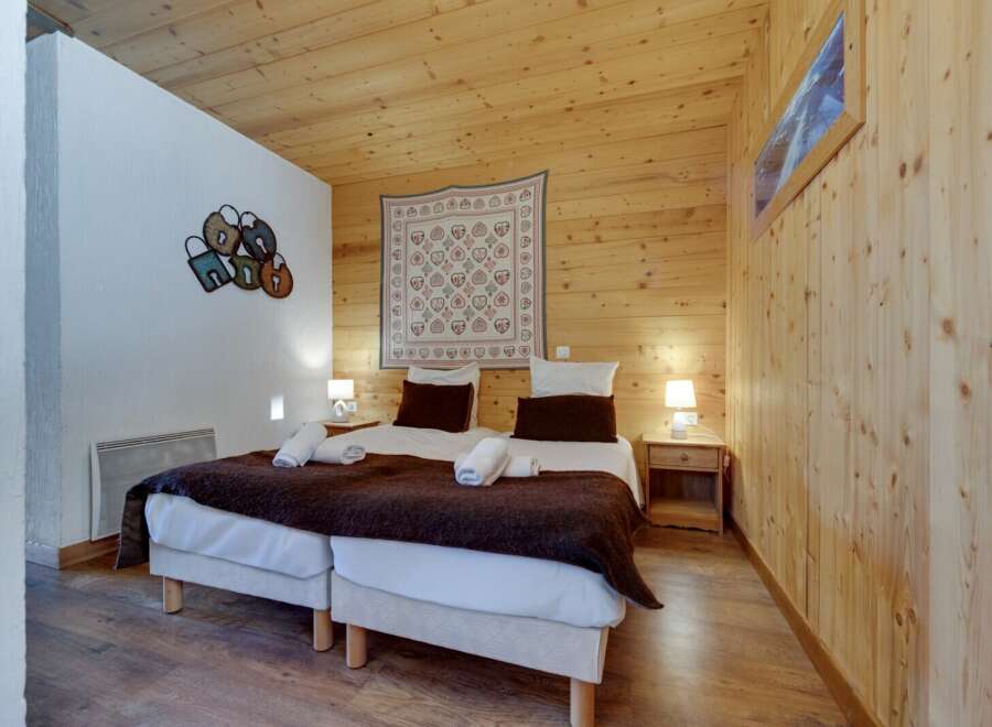 This cozy bedroom features a warm wooden interior, creating a welcoming atmosphere.