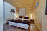 This cozy bedroom features a warm wooden interior, creating a welcoming atmosphere.