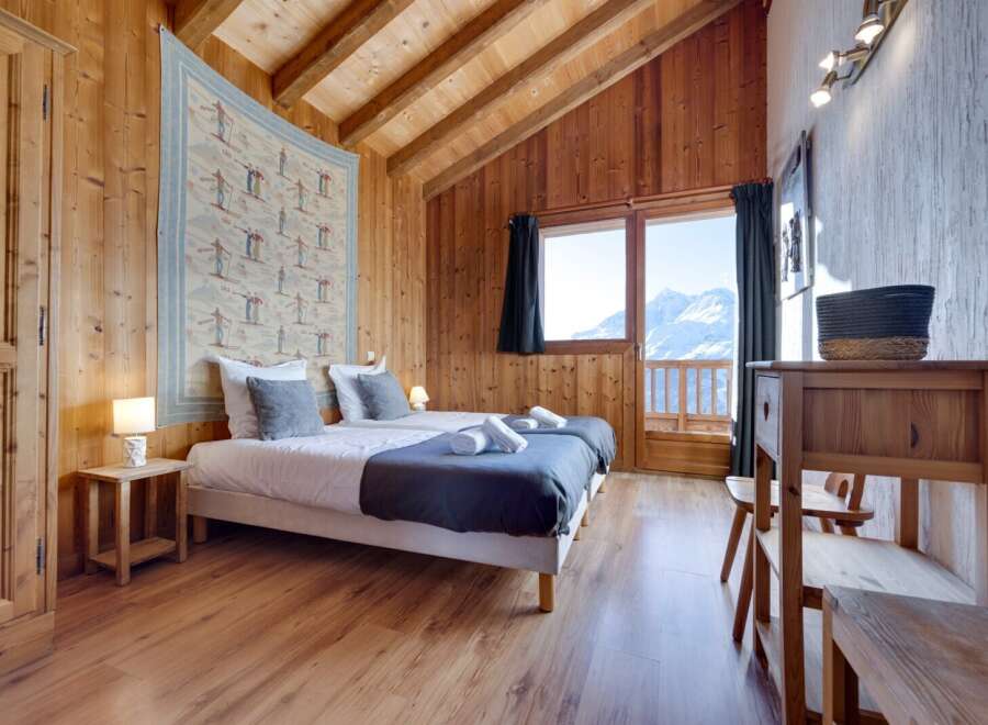 This cozy bedroom features a rustic wooden interior, creating a warm and inviting atmosphere.