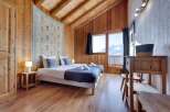 This cozy bedroom features a rustic wooden interior, creating a warm and inviting atmosphere.