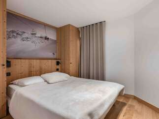 Experience the cozy charm of this bedroom, featuring a unique mountain-themed wall art that adds a touch of adventure.