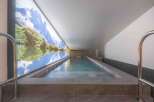 Experience tranquility in this luxurious indoor pool, featuring a stunning mountain mural that creates a serene atmosphere.