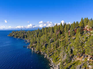 Nestled along the pristine shoreline, this stunning property offers unparalleled views of the crystal-clear lake.