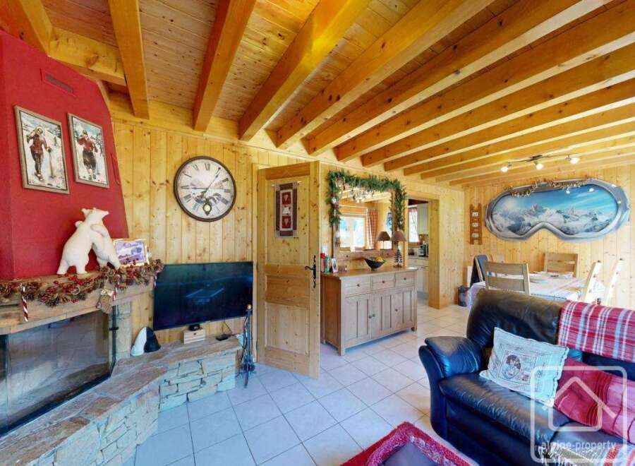 Experience the charm of this cozy chalet, featuring a rustic fireplace and wooden accents throughout.