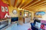 Experience the charm of this cozy chalet, featuring a rustic fireplace and wooden accents throughout.