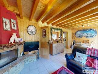 Experience the charm of this cozy chalet, featuring a rustic fireplace and wooden accents throughout.