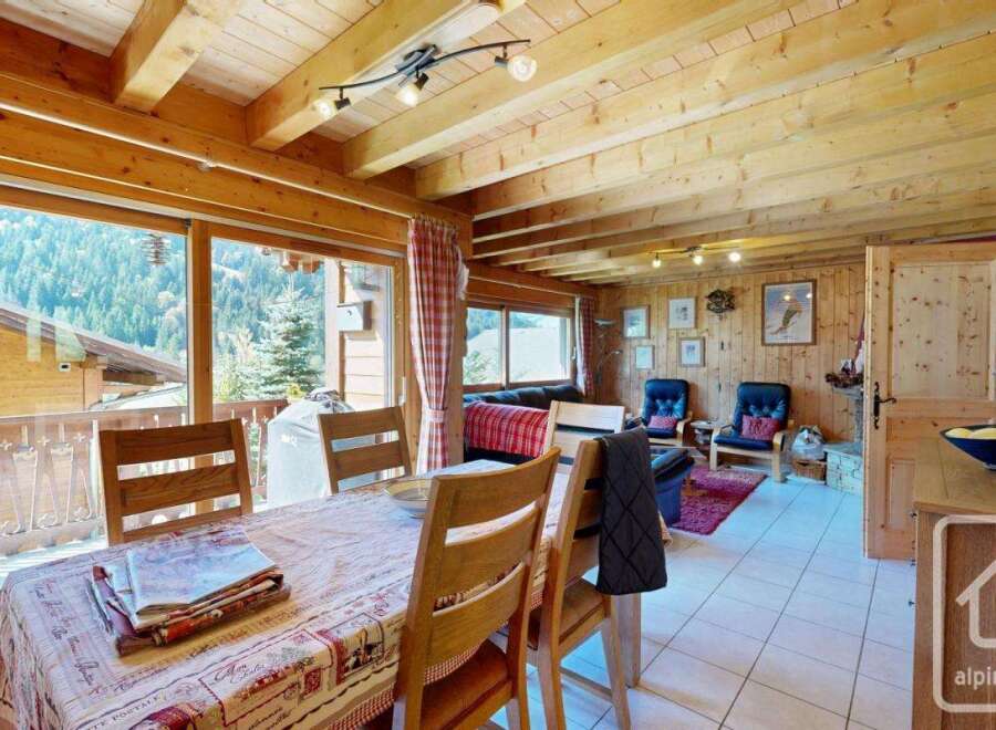Experience the charm of this stunning property, featuring a warm and inviting interior with exposed wooden beams and paneling.