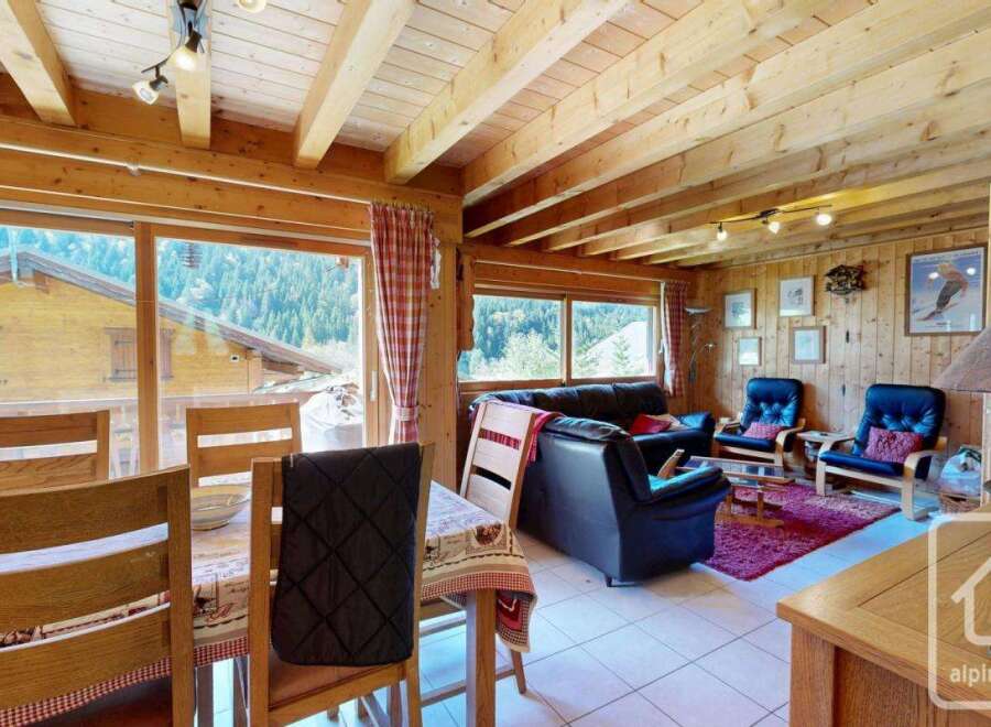 Experience the charm of this cozy chalet, featuring stunning wooden interiors and panoramic views.