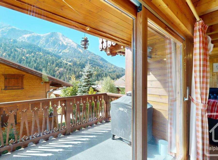 Enjoy breathtaking mountain views from this charming chalet balcony.