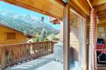 Enjoy breathtaking mountain views from this charming chalet balcony.
