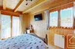 This charming bedroom features a cozy wooden interior, creating a warm and inviting atmosphere.