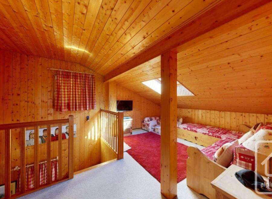 Discover the charm of this cozy wooden-paneled interior, perfect for a mountain retreat.