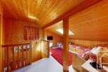 Discover the charm of this cozy wooden-paneled interior, perfect for a mountain retreat.