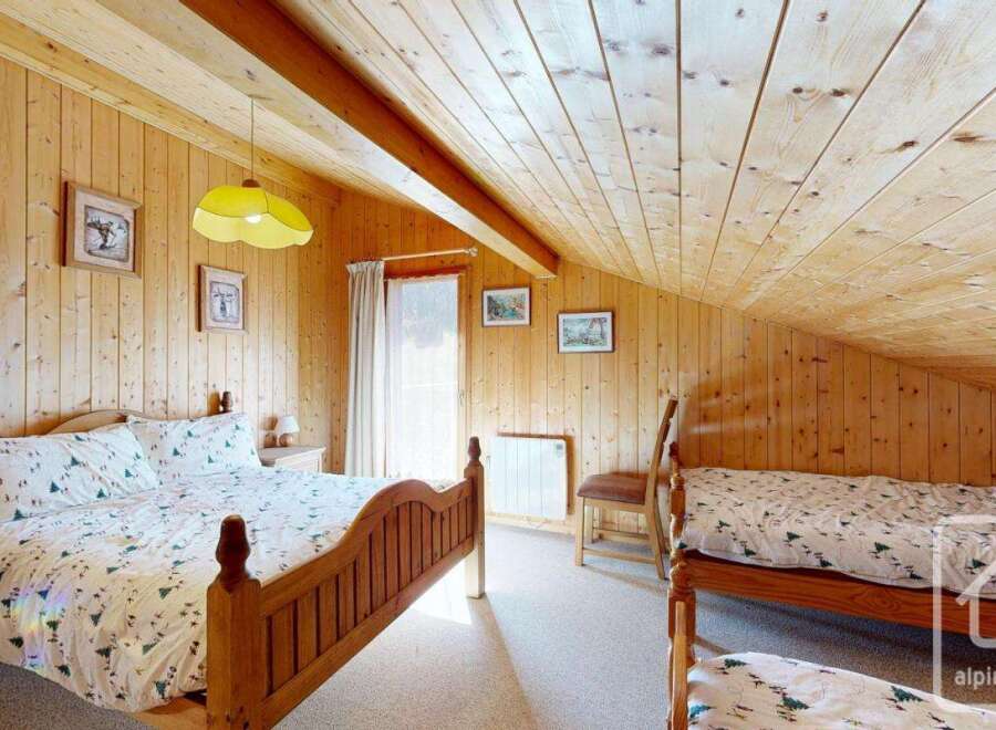 This charming bedroom features a cozy wooden interior, creating a warm and inviting atmosphere.