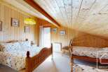 This charming bedroom features a cozy wooden interior, creating a warm and inviting atmosphere.