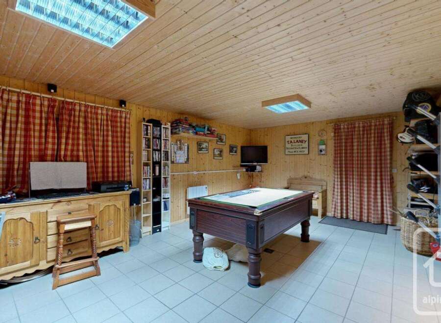 Step into this charming property featuring a cozy interior with wooden paneling and a welcoming atmosphere.