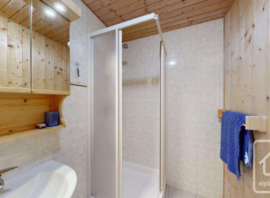 This charming bathroom features a cozy wooden design, creating a warm and inviting atmosphere.