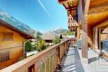 Experience the charm of this stunning chalet, boasting exquisite wooden architecture and breathtaking mountain views.
