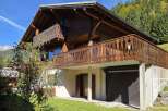 Discover a charming wooden chalet nestled in a picturesque mountain setting.