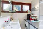Discover this charming property featuring a well-lit bathroom with a double sink and a convenient washing machine.