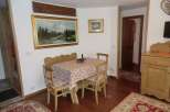 This charming property features a cozy dining area with a wooden table and chairs, perfect for enjoying meals.
