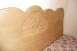 This charming property features a beautifully crafted wooden headboard, adding a touch of rustic elegance to the bedroom.