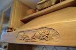This stunning kitchen boasts custom woodwork, including a beautifully carved range hood.