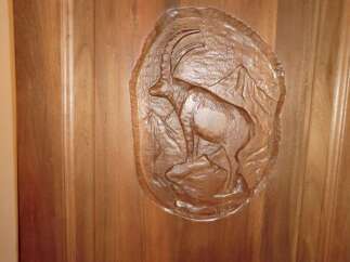This stunning property features a beautifully crafted wooden door, showcasing intricate artistry.