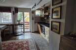 Discover the charm of this cozy kitchen with its warm wooden cabinetry and inviting atmosphere.