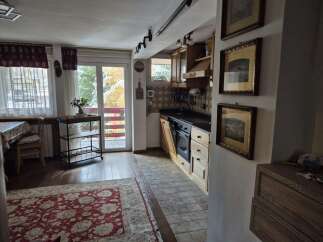 Discover the charm of this cozy kitchen with its warm wooden cabinetry and inviting atmosphere.