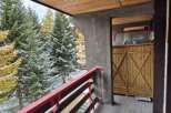 Enjoy breathtaking views from this charming balcony! This property features a cozy wooden balcony with a vibrant red railing, perfect for relaxing and taking in the surrounding natural beauty.