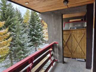 Enjoy breathtaking views from this charming balcony! This property features a cozy wooden balcony with a vibrant red railing, perfect for relaxing and taking in the surrounding natural beauty.