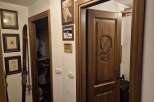 This inviting entryway showcases a beautifully crafted wooden door with an intricate eagle carving, setting a tone of rustic elegance.