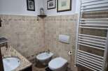 This charming bathroom features a classic design with tiled walls and a cozy atmosphere.