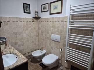 This charming bathroom features a classic design with tiled walls and a cozy atmosphere.