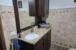 This stunning bathroom boasts a beautiful vanity with a granite countertop and a stylish sink.