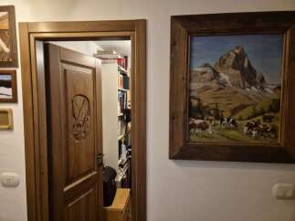 Discover the charm of this unique property, featuring a beautifully carved wooden door that leads to a hidden library.