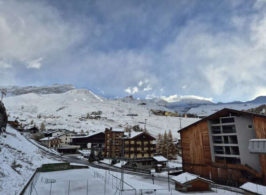 Discover the charm of mountain living in this stunning property, nestled amidst a picturesque snow-covered landscape.