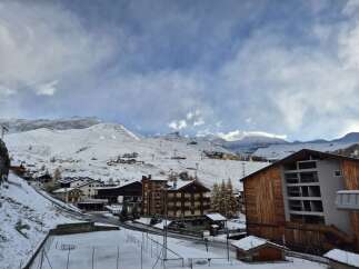Discover the charm of mountain living in this stunning property, nestled amidst a picturesque snow-covered landscape.